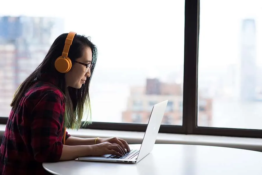 woman working at laptop with headphones
