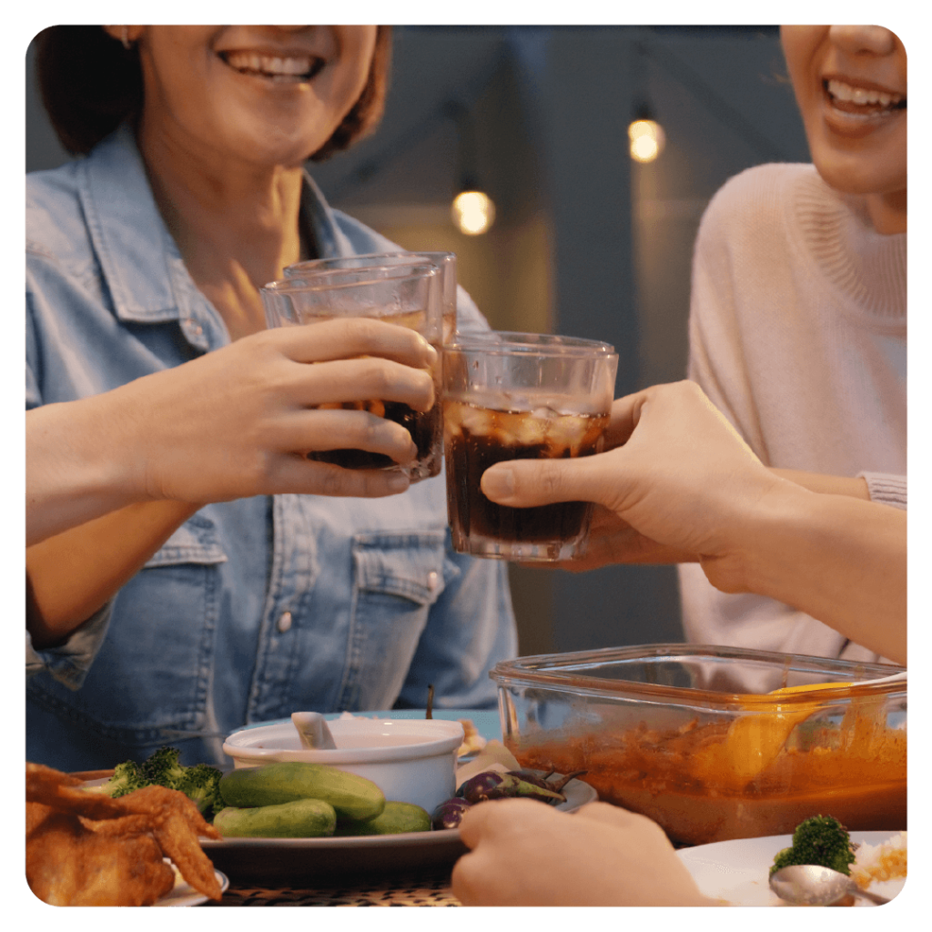 Family sharing sodas over the dinner table